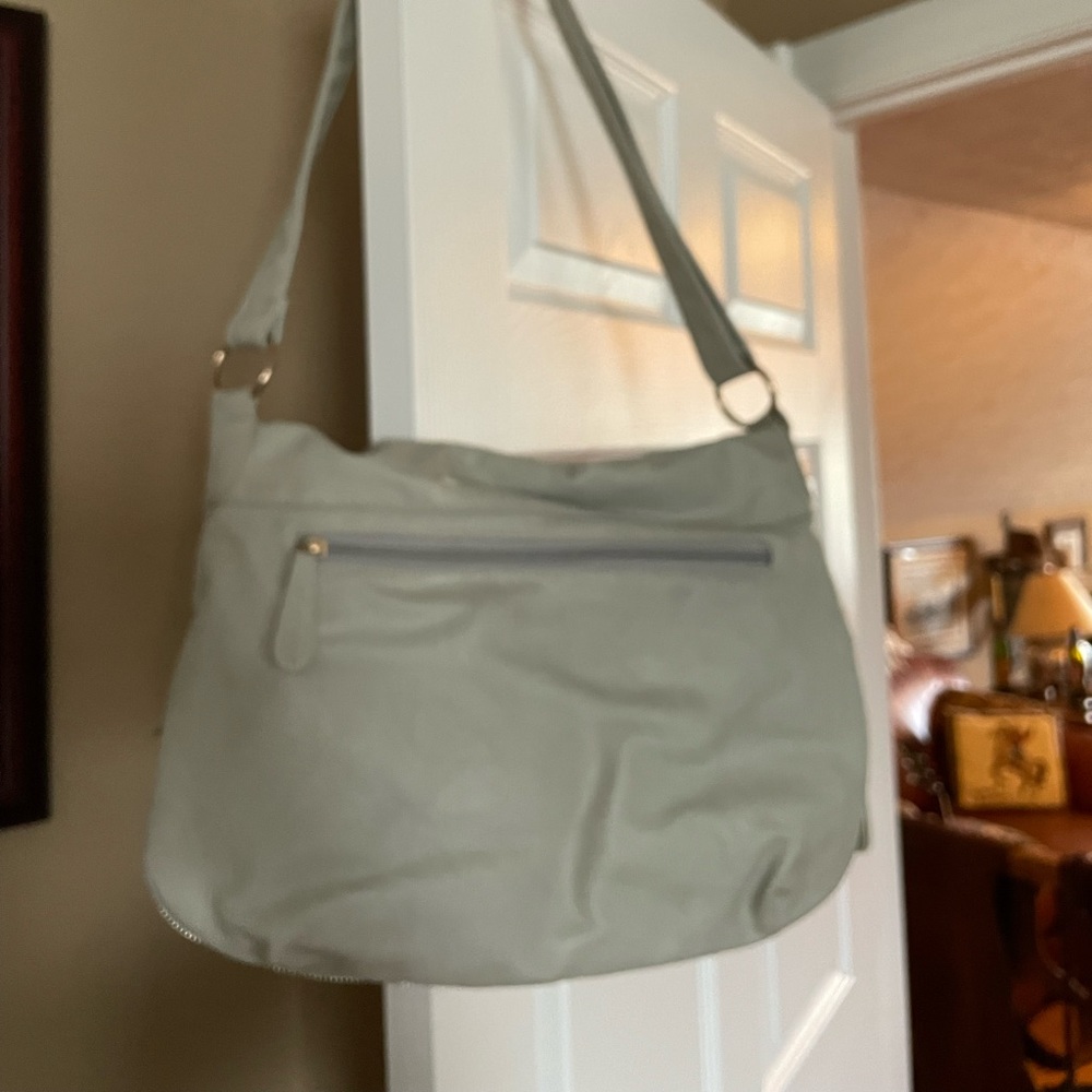 Crossbody bag; gray with teal lining; very spacious, great for travel.